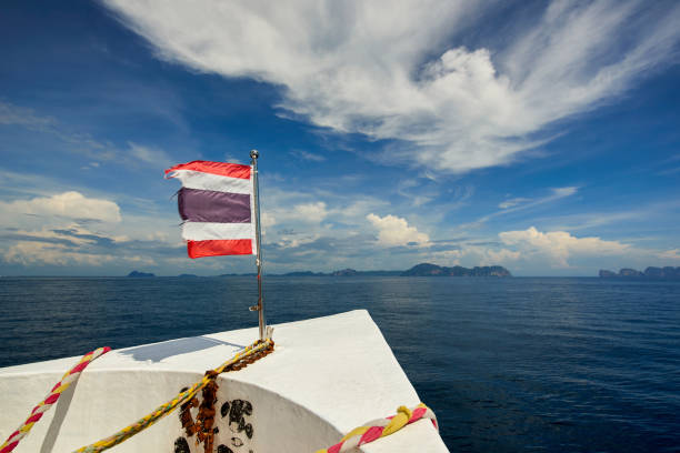 istock Thailand flag with boat sails to Koh Phi Phi island, Thailand 641787458