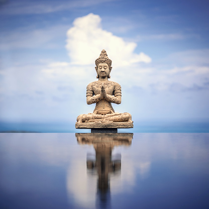 Peaceful Buddha Statue Against Tranquil Sky