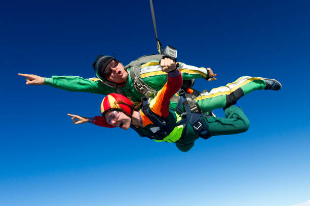 istock Tandem jump. The girl with the instructor in freefall. 641792754