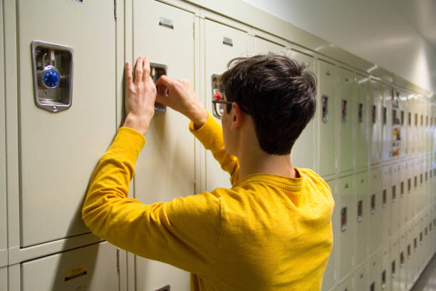 istock Teen Unlocking Locker in Hallway 641792808