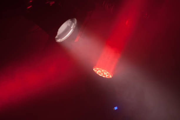 istock Stage spot lights with red beams in smoke 641794296