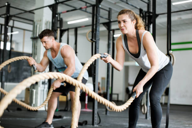 istock Fitness people working out with battle ropes 641794578