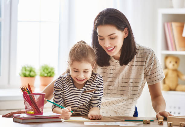 istock woman teaches child the alphabet 641798412