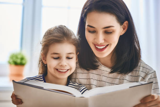 istock mother and daughter reading a book 641798538
