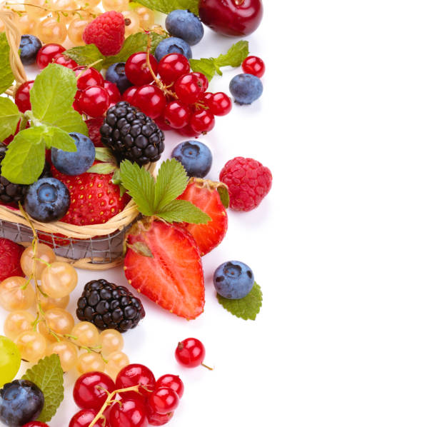 Different types of berries on a black wooden background. Raspberry, strawberry, cherry and currant in a plate. High quality photo