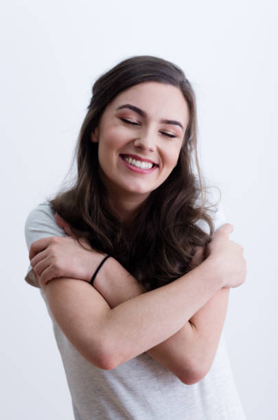 istock Girl in white t-shirt hugging herself 641803536
