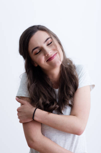 istock Girl in white t-shirt hugging herself 641803538