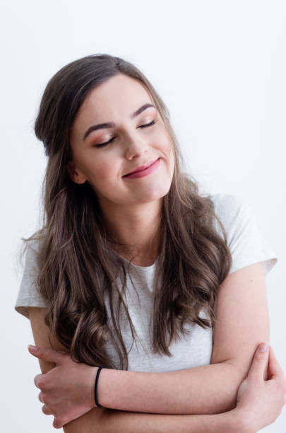 istock Girl in white t-shirt hugging herself 641803542