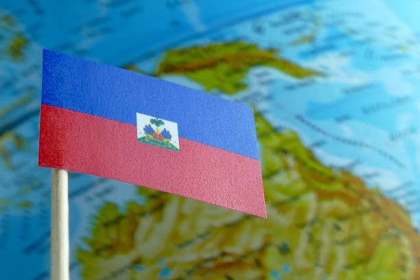 istock Haiti flag with a globe map as a background macro 641805068