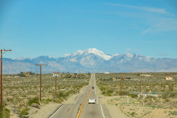 The famous Route 40 paved road parallel to the Andean mountains against a blue sky, Jujuy Province. Argentina 2014 (Selective focus on the road)