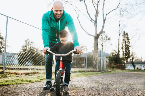 istock Dad Teaching Son to Ride Bike 641805814