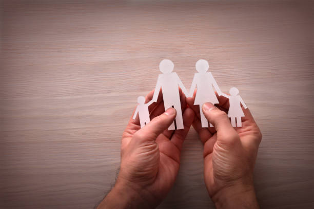 istock Concept of family protection with hands around catching them 641806378
