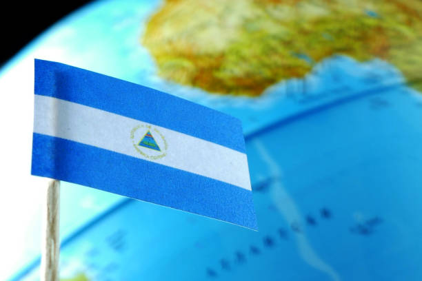 Nicaragua flag with a globe map as a background macro