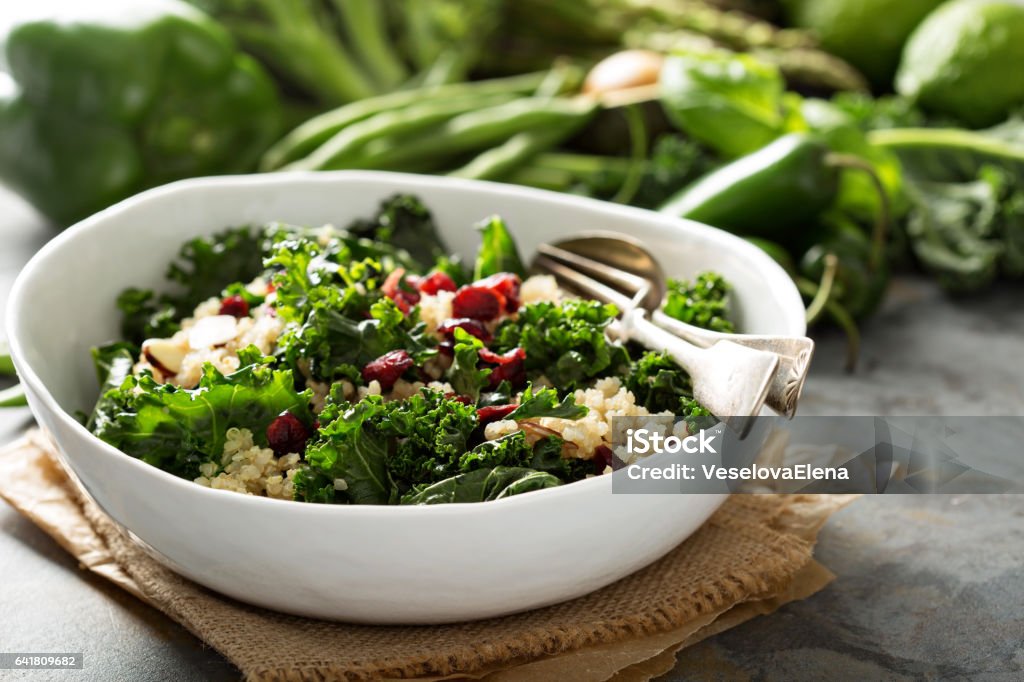 Healthy kale and quinoa salad Healthy raw kale and quinoa salad with cranberry and almonds Salad Stock Photo
