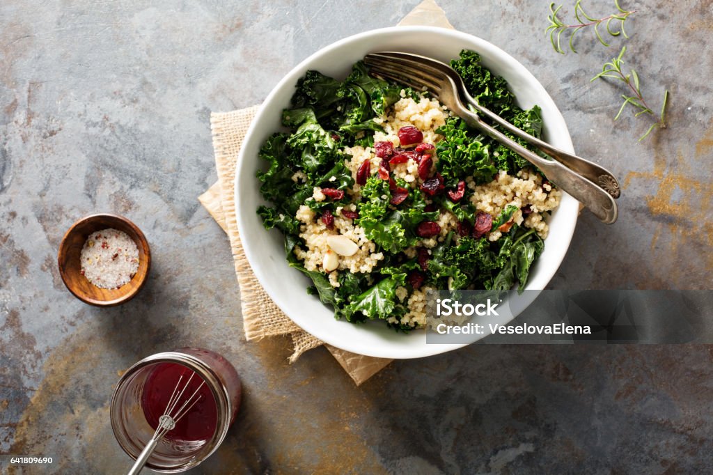 Healthy kale and quinoa salad Healthy raw kale and quinoa salad with cranberry and almonds Quinoa Stock Photo
