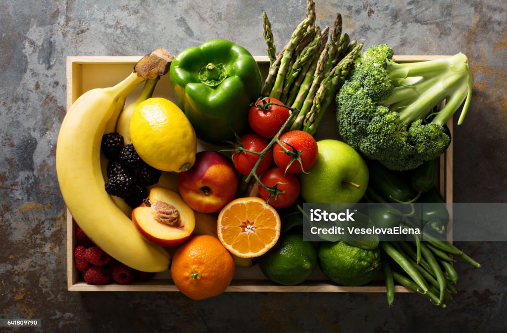 Fresh colorful vegetables and fruits Fresh and colorful vegetables and fruits in a wooden crate Vegetable Stock Photo