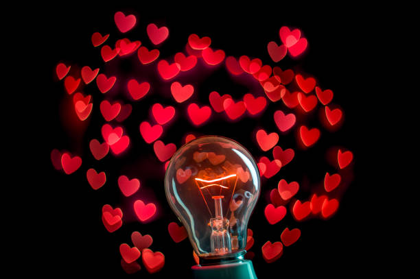 istock Lighting bulb with beautiful red heart bokeh background 641810436
