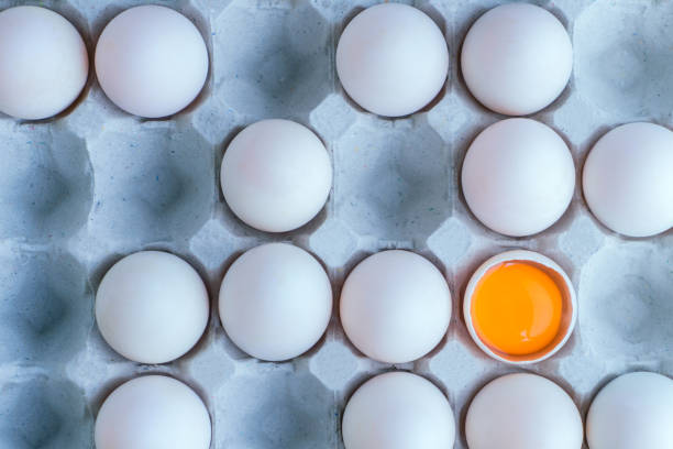 istock Fresh white eggs with yolk on cardboard tray 641810914