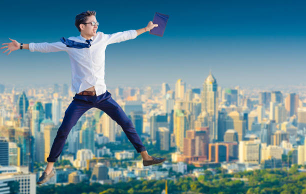 istock Young business man using laptop and digital tablet cityscape background 641811160