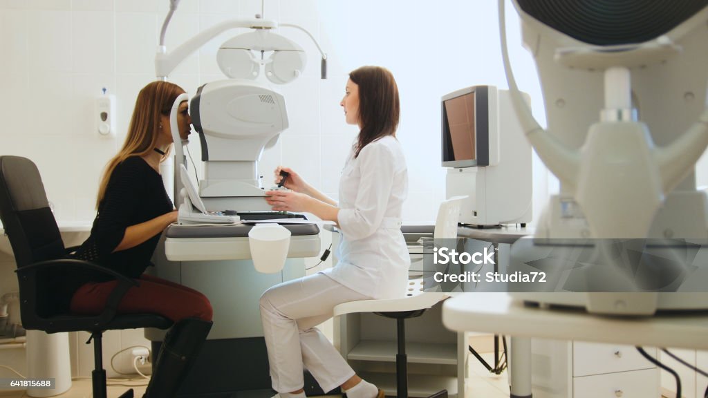 Optician with tonometer and patient at eye clinic, diagnostic Optician with tonometer and patient at eye clinic, diagnostic, horizontal Ophthalmologist Stock Photo