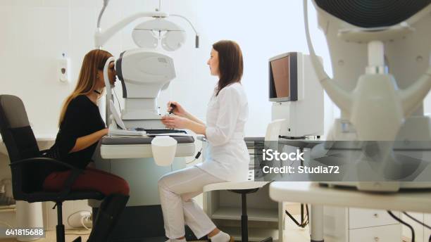 Optician With Tonometer And Patient At Eye Clinic Diagnostic Stock Photo - Download Image Now