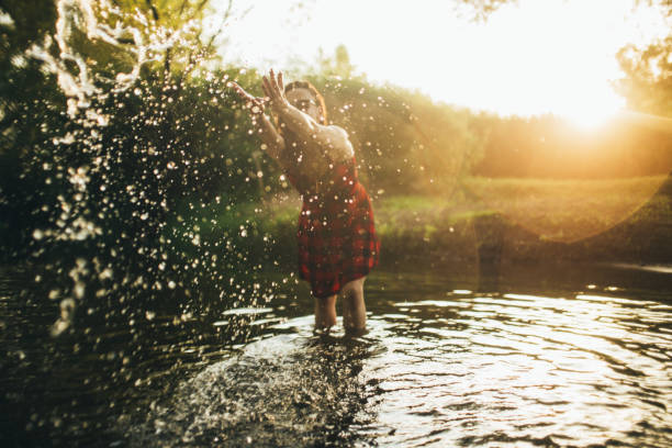 istock Girl playing in river 641819738