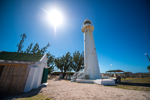 Cockburn Town, Turks and Caicos Islands - January 18, 2017: Historic Grand Turk Lighthouse, famous attraction on Grand Turk island. Tourists visiting on background.