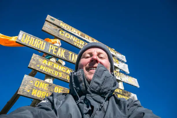 Photo of Man at Uhuru Peak, Mount Kilimanjaro