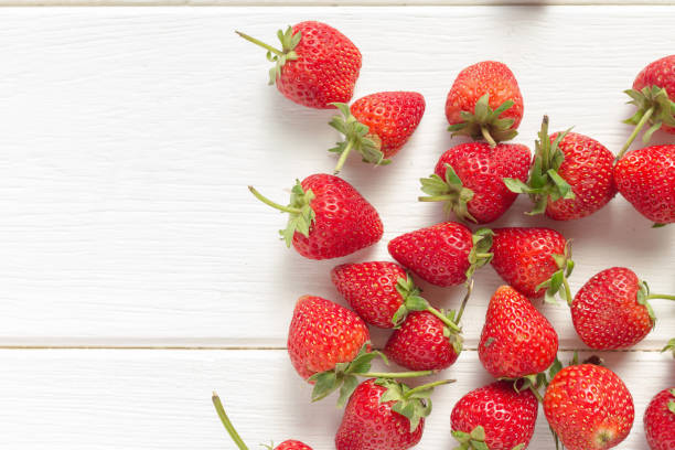 istock Fresh strawberries on white wooden table. 641833732