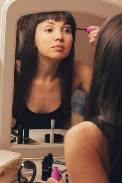 istock Girl doing makeup, paints eyelashes. 641834286