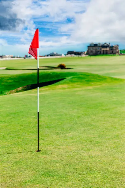 Golf flag on a putting green on the Old Course at St.Andrews in Scotland.