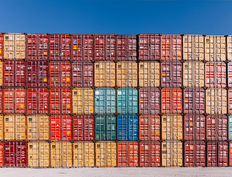 Background of colorful cargo freights container stacks in shipping port