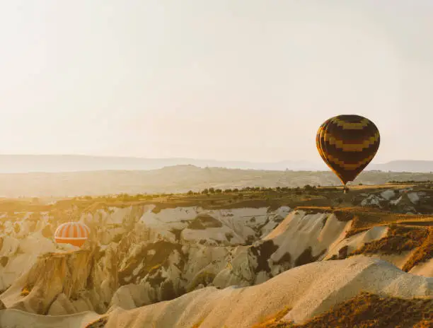 Photo of Hot air balloons flighing high during sunrise at Cappadocia