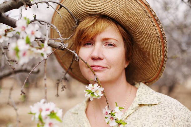 istock Happy woman in spring blossom park. soft backlight 641837932
