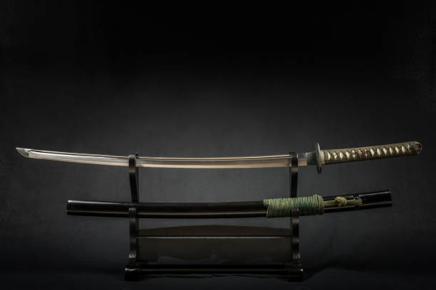 Japanese iaido sword in black wooden stand and black background. stock photo