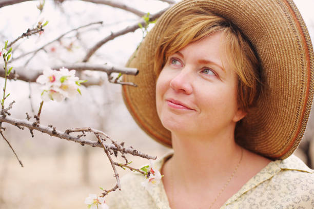 istock Happy standing woman in spring blossom park 641841530