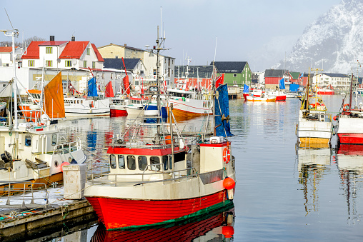 Fishing boats in the harbour of Henningsvaer a fishing village located on several small islands off the southern coast of Austvagoya in the Lofoten archipelago in Norway.