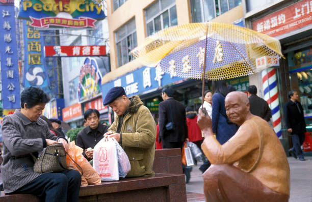 Beijing, China - July 21, 2013 - Vendor sells Chinese antiques to customers in the Baoguosi antique market.