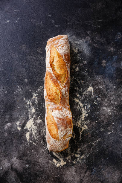 Baguette bread Fresh Baguette bread on dark background copy space baguette stock pictures, royalty-free photos & images