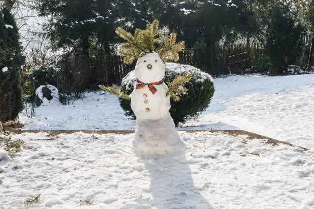 Photo of Snowman in the garden at first snow in the winter