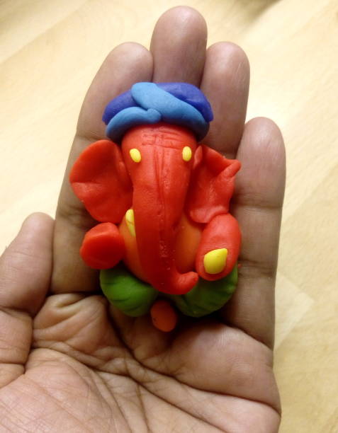istock Ganesha idol in hand made of clay 641846278