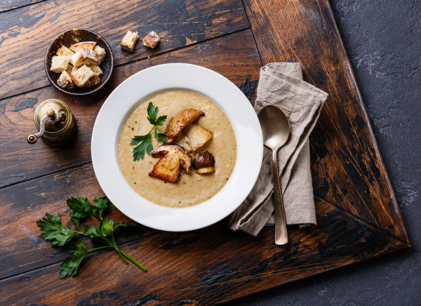 Cream-soup with porcini mushroom Cream-soup with porcini mushroom with croutons on wooden table porcini mushroom stock pictures, royalty-free photos & images