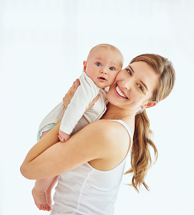 Portrait of a mother bonding with her adorable baby boy at home