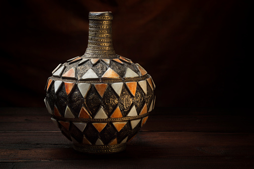 Antique Moroccan vase on an old dark table