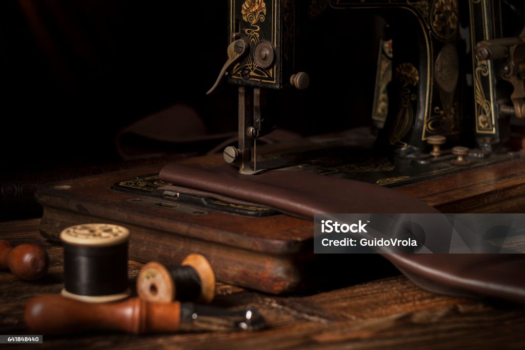 Old sewing machine Old sewing machine and leather working tools Leather Stock Photo