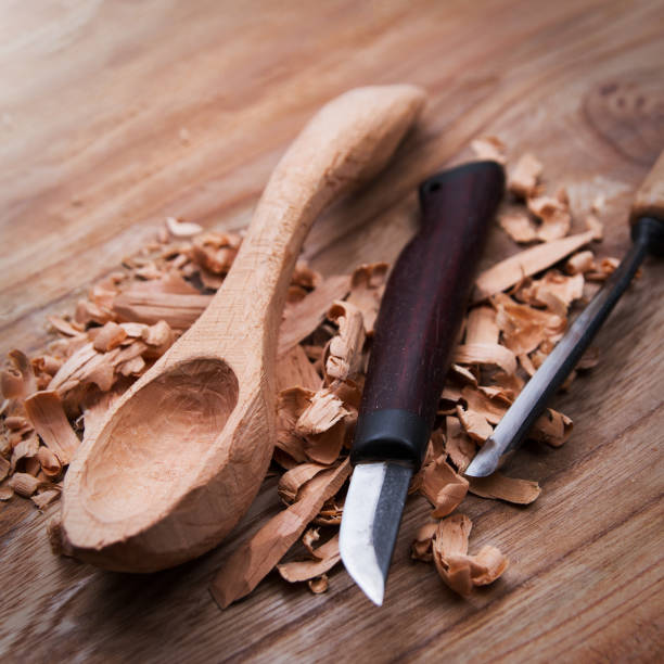 istock Wooden spoon with carvin tools 641849792
