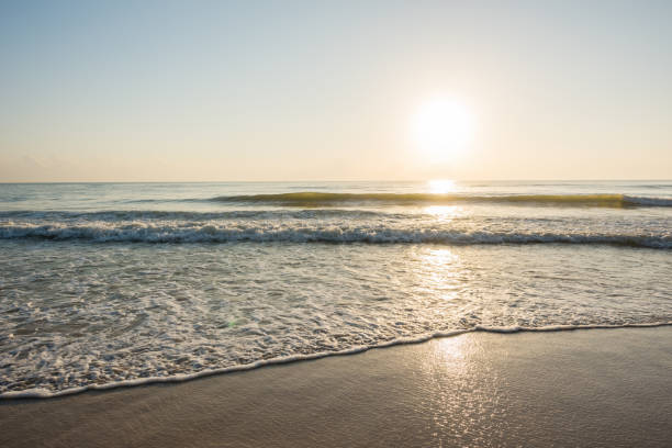 istock Beautiful sunrise and ripple wave at the tropical beach 641850034