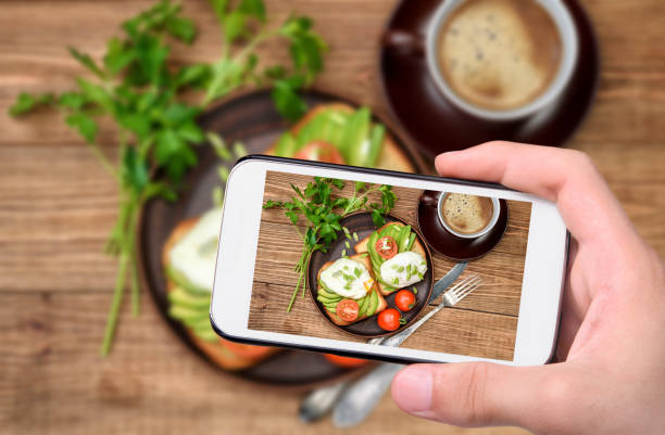 istock Hands taking photo sandwich with avocado and poached egg with smartphone. 641850220