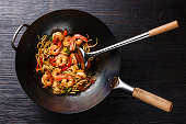 Udon stir-fry noodles with shrimp and vegetables in wok pan