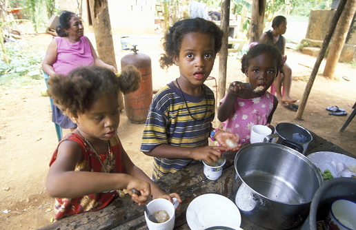 childern in a kitchen at the Village of Las Terrenas on Samanaon in The Dominican Republic in the Caribbean Sea in Latin America.